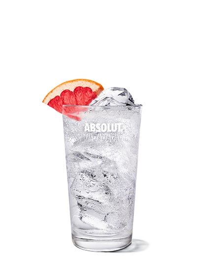 grapefruit vodka soda against white background